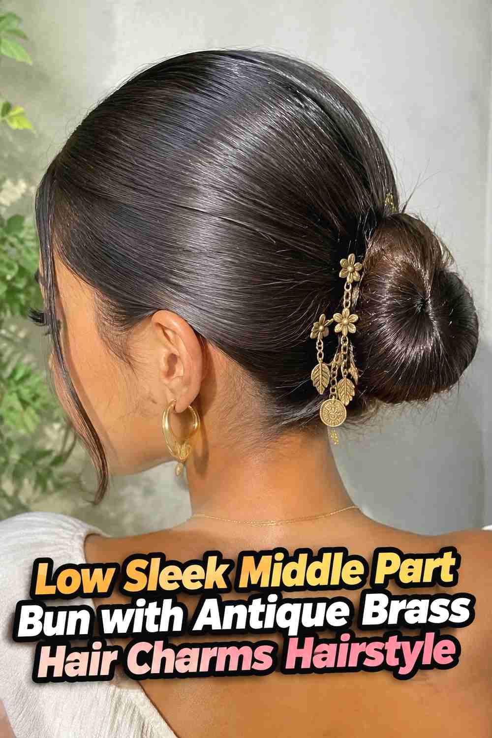 2. Low Sleek Middle Part Bun With Antique Brass Hair Charms Hairstyle