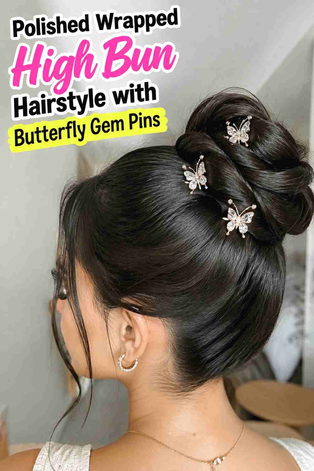 3. Polished Wrapped High Bun Hairstyle With Butterfly Gem Pins