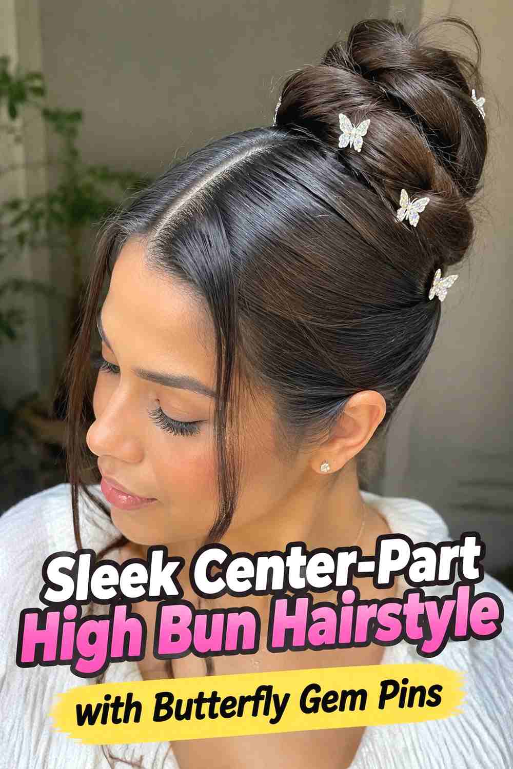 1. Sleek Center Part High Bun Hairstyle With Butterfly Gem Pins