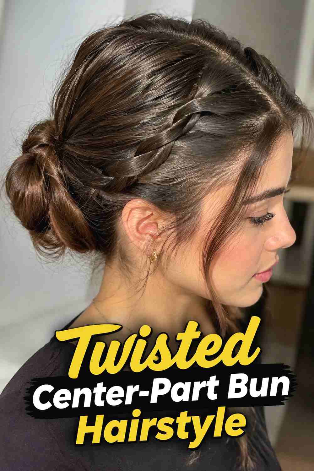 4. Twisted Center Part Bun Hairstyle
